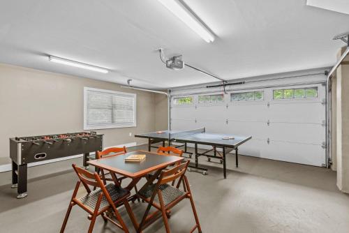 a ping pong room with two ping pong tables and chairs at Starlight Ridge in Seven Devils