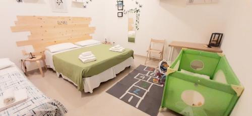 a bedroom with a green bed and a chair at LA MURGIA casa vacanze B&B in Grumo Appula