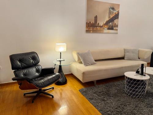 a living room with a couch and a chair at Central Glyfada 2BR Apartment in Athens