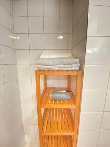 a shelf in a shower with a towel on it at The Abe Ikebukuro in Tokyo