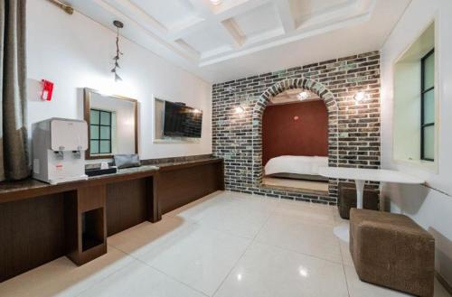 a room with a bed and a brick wall at Yeongdeungpo Ciel Hotel in Seoul