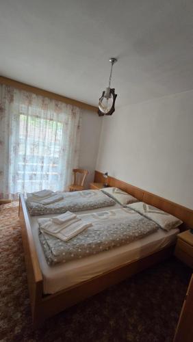a bedroom with a large bed with a light on it at Appartamenti Bernard Sas in Canazei