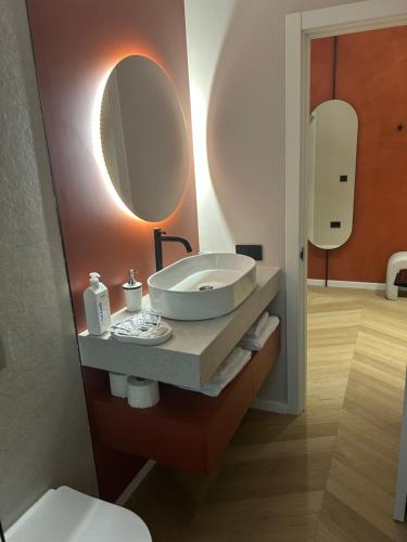 a bathroom with a sink and a mirror at Premium Art Deco Loft in Iaşi