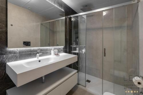 a bathroom with a sink and a shower at Sunset Cliffs Apartment by Leo Apartments Benidorm in Benidorm