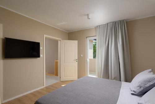 a bedroom with a bed and a flat screen tv at Villa Casa della Capra by Istrialux in Foli