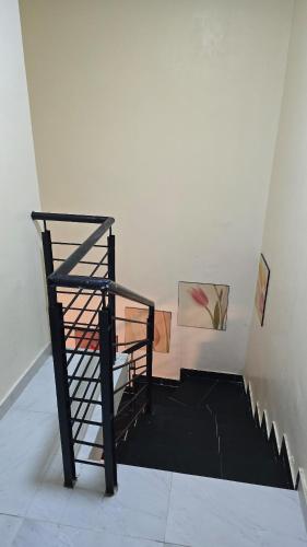 a spiral staircase in a room with paintings on the wall at Haven Height Executive Luxury Apartment in Lekki