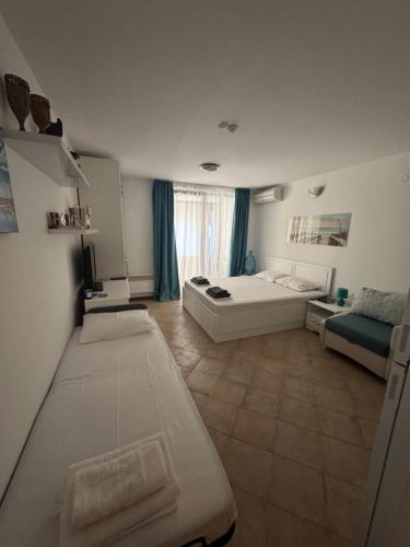 a large room with two beds and a couch at Heritage in Oasis Resort Lozenets in Lozenets