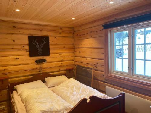 a bedroom with a bed in a log cabin at Blazerbu Four-Bedroom Chalet in Hol