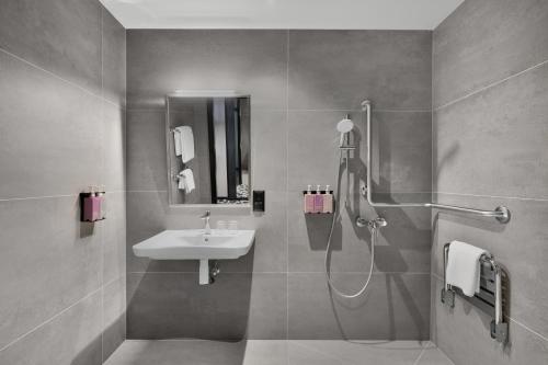 a bathroom with a sink and a shower at TRIBE Budapest Airport in Budapest