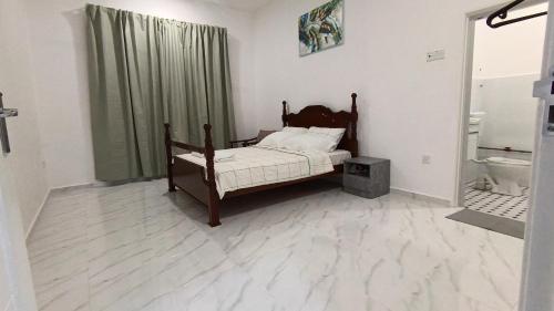 Postel nebo postele na pokoji v ubytování Homestay Rahmat 2