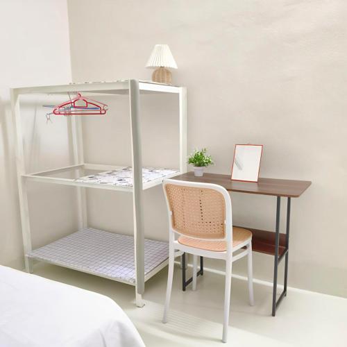 a desk and a chair next to a table and a bed at Simee Terrance Cozy Stay in Gua Sai