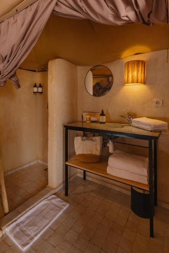 a bathroom with a sink and a mirror at Mia Agafay Resort in El Karia
