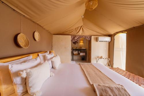 a bedroom with a bed in a tent at Mia Agafay Resort in El Karia