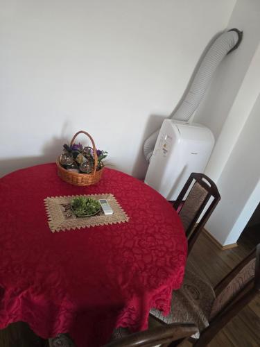 a red table with a basket on top of it at Zuto brdo Batinac 