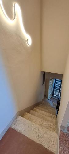 a staircase in a house with lights on the ceiling at La Gatta in Montemerano