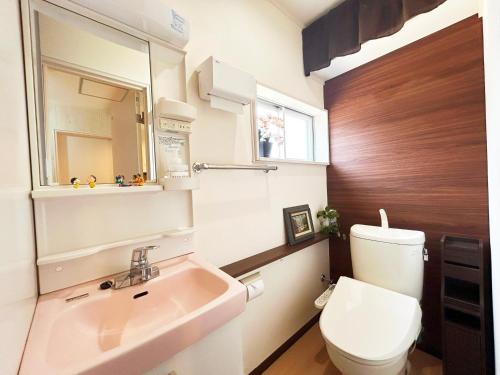 a small bathroom with a sink and a toilet at Guest House TAKAO in Tanabe
