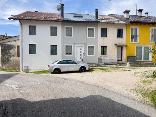 a white car parked in front of a white house at Terrazzo Panoramico - Vicino ad Asiago in Roana