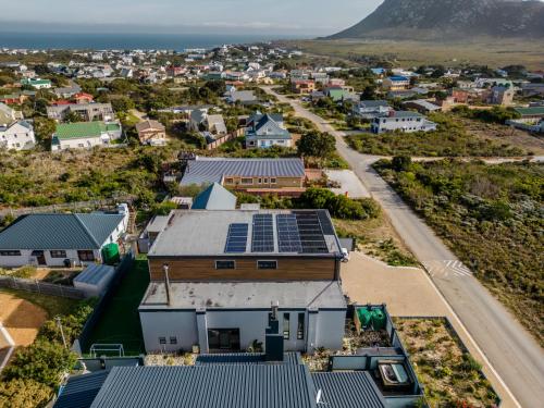 an aerial view of a town with solar panels on a building at Escape to Pringle in Pringle Bay