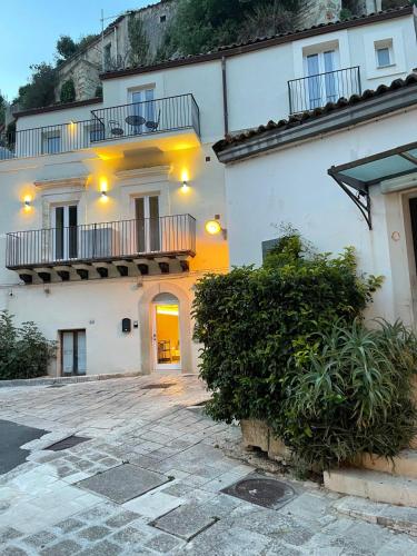 a white building with a balcony on top of it at Moronero in Ragusa
