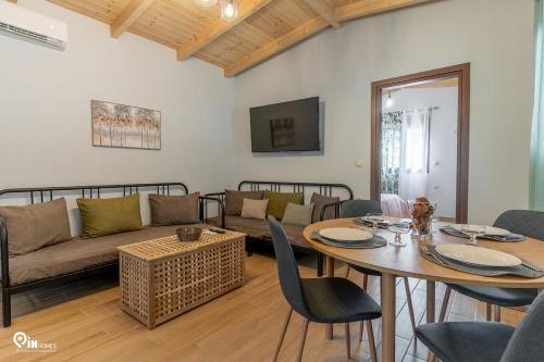 a living room with a couch and a table at Myrtali's Guesthouse Ιn Tzoumerka 
