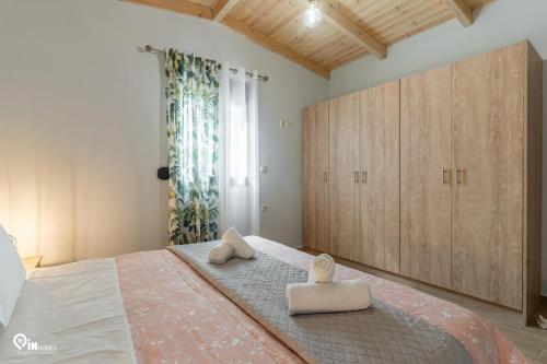 a bedroom with a large bed and wooden cabinets at Myrtali's Guesthouse Ιn Tzoumerka 