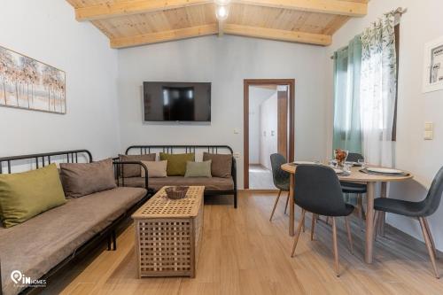 a living room with a couch and a table at Myrtali's Guesthouse Ιn Tzoumerka 