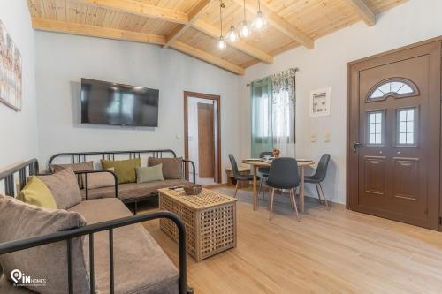 a living room with a couch and a table at Myrtali's Guesthouse Ιn Tzoumerka 