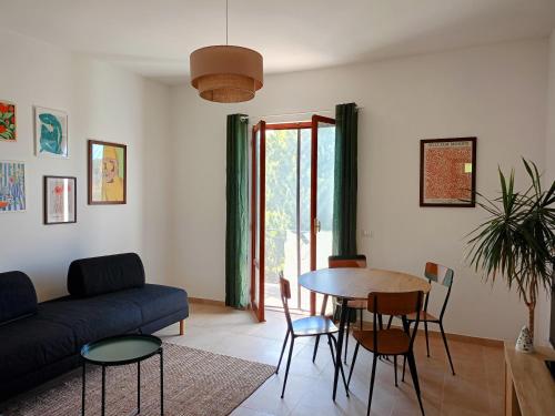 a living room with a table and a couch at Casa Otrì in Otricoli