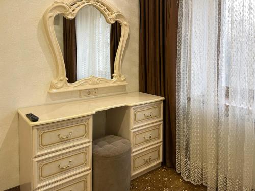a white dresser with a mirror on top of it at VitaPark Stariy Dub in Truskavets