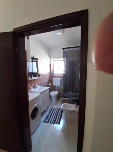 a bathroom with a sink and a washing machine at Apartment Ana in Senj
