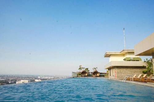 a swimming pool on the top of a building at Comfy Studio Room Apartment in Semarang