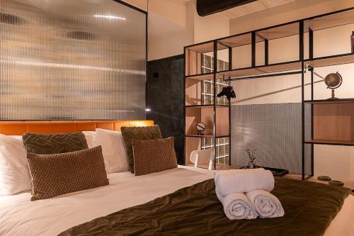 a bedroom with a bed with two towels on it at Zekka House in Valletta