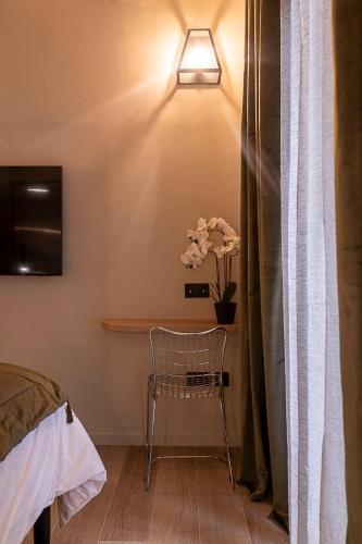 a room with a bed and a chair and a light at Zekka House in Valletta