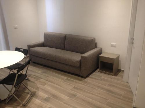 a couch in a living room with a table at Residence Fanny in Alassio