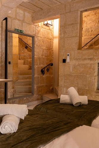 a bedroom with a large bed and a shower at Zekka House in Valletta