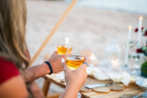 two people holding up glasses of beer at a table at InterContinental Aqaba by IHG in Aqaba