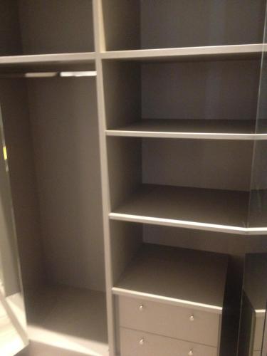 a closet with white shelves and white drawers at Residence Fanny in Alassio