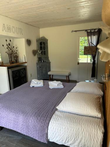 a bedroom with two beds with towels on them at chambre d hôtes les trois châteaux in Notre-Dame-de-Riez