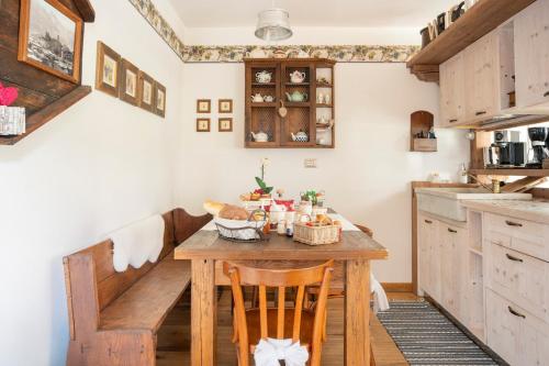 a kitchen with a wooden table in a room at B&B Ca' La Vedescia in Teglio