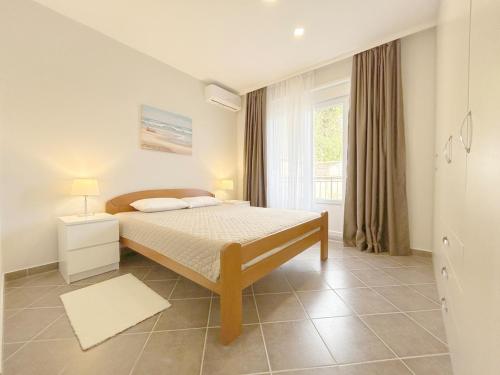 a bedroom with a bed and a window at Incredible views 2-bd apartment in Kravlja