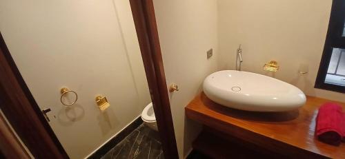a bathroom with a white sink and a toilet at Luxury Villa with Pool & Garden in Casablanca in Tamaris