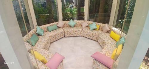 a couch with colorful pillows on it in a room at Luxury Villa with Pool & Garden in Casablanca in Tamaris
