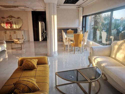 a living room with a couch and a table at Luxury Villa with Pool & Garden in Casablanca in Tamaris
