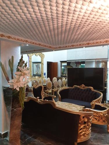 a living room with a couch and a mirror at Luxury Villa with Pool & Garden in Casablanca in Tamaris