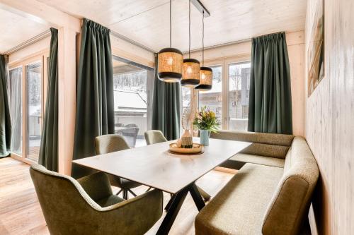 a dining room with a table and chairs at Familienferienwohnung Zentral by A-Appartments in Brand