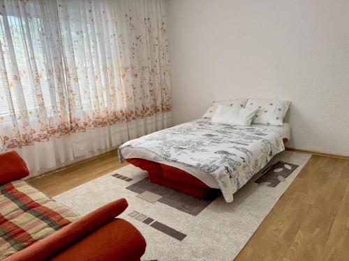 a bedroom with a bed and a couch at Podujeva - Home Sweet Home in Orllan