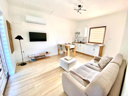 a living room with a couch and a table at BorászPorta KisHáz in Villány
