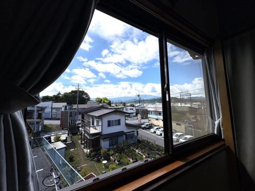 an open window with a view of a city at Nikko-Imaichi "The LINKs" Dormitory House in Nikko