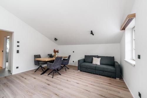 a living room with a table and a couch at Stadthaus Rosengartenschlucht in Imst