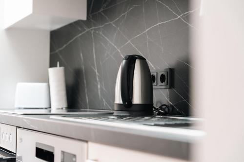 a coffee pot sitting on top of a stove in a kitchen at Stadthaus Rosengartenschlucht in Imst
